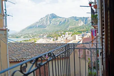 a view of a mountain from a balcony with buildings at Appartamento in Centro Storico a Termini Imerese - Eden Holiday Home in Termini Imerese