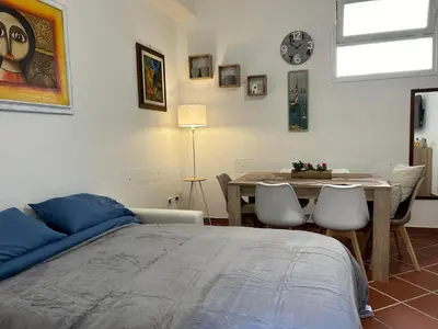 a bedroom with a bed and a table with chairs at Corte dei Re di Palermo Apartment in Palermo