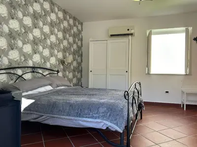 a bedroom with a bed with a blue blanket at Corte dei Re di Palermo Apartment in Palermo