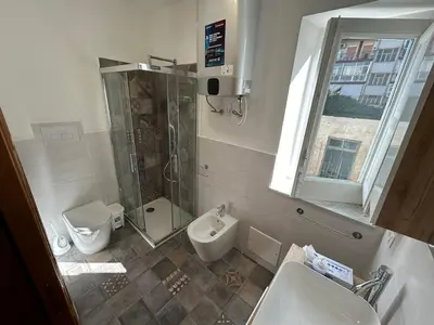 a bathroom with a shower and a toilet and a sink at Corte dei Re di Palermo Apartment in Palermo