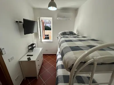 a bedroom with a bed and a television in it at Corte dei Re di Palermo Apartment in Palermo