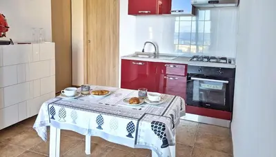 a kitchen with a table with plates of food on it at VISTA MARE in Alcamo Marina