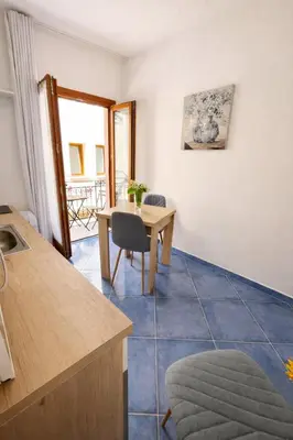 a kitchen and dining room with a table and chairs at Oikos Design Sicily in Castellammare del Golfo