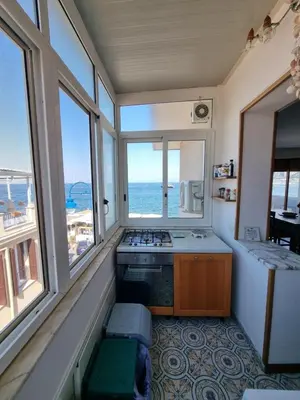 a kitchen with a view of the ocean at Villa Emilia Mondello Appartamento Emily con vista sul mare in Palermo