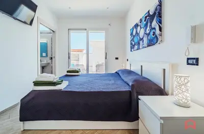 a bedroom with a large bed and a window at Villa con Piscina sul Mare a Terrasini in Terrasini