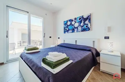 a bedroom with a bed with towels on it at Villa con Piscina sul Mare a Terrasini in Terrasini