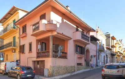 a building with cars parked on the side of a street at 4 Bedroom Stunning Home In Trappeto in Trappeto