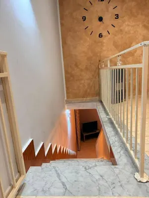 a staircase with a large clock on the wall at Casa Julia in Palermo