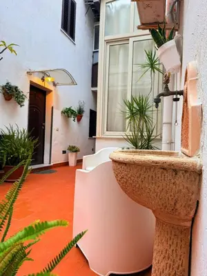 a planter on the side of a building with plants at Casa Julia in Palermo