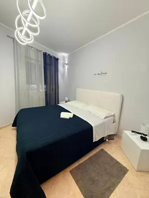 a bedroom with a large bed with a black blanket at Casa Julia in Palermo