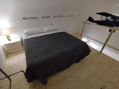 a bedroom with a bed with a black blanket at Casa Veni Ka in Palermo