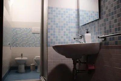 a bathroom with a sink and a toilet at Al bastione della pace in Palermo