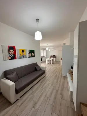 a living room with a brown couch in a white room at Casa Andrew in Terrasini