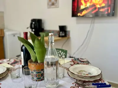a table with a bottle of water and a plant at La Dimora di Anna e Ciccio in Casteldaccia