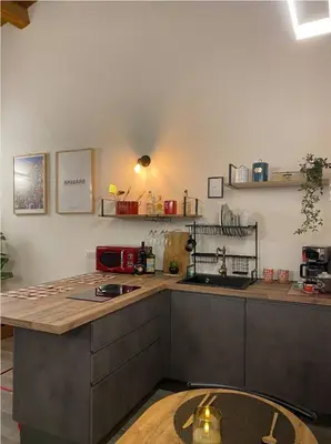 a kitchen with a counter top and a table at La Barbera's apatments old town PA in Palermo