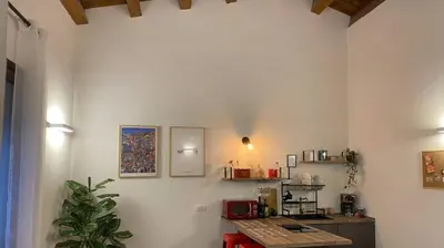 a room with a desk and a computer on a wall at La Barbera's apatments old town PA in Palermo