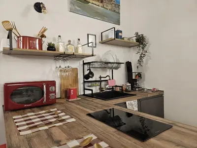 a kitchen with a red microwave on a wooden table at La Barbera's apatments old town PA in Palermo