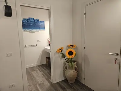a bathroom with a vase with flowers in it at La Barbera's apatments old town PA in Palermo