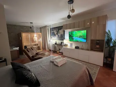 a bedroom with a bed and a flat screen tv at Casita Garden&Spa in Carini