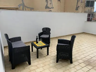 two chairs and a table with a bottle of wine at GEORGE PENTHOUSE Attico PALERMO in Palermo