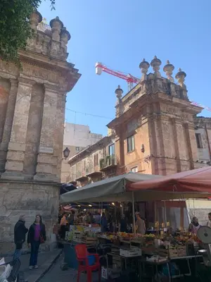 a market in front of a building with a crane at GEORGE PENTHOUSE Attico PALERMO in Palermo