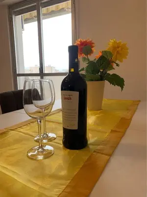 a bottle of wine and a glass on a table at GEORGE PENTHOUSE Attico PALERMO in Palermo