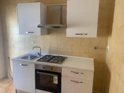 a small kitchen with a stove and a sink at GEORGE PENTHOUSE Attico PALERMO in Palermo