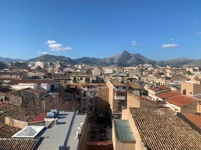 a view of a city with buildings and mountains at GEORGE PENTHOUSE Attico PALERMO in Palermo