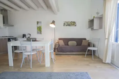 a living room with a table and chairs and a couch at Casa Gelsomino POOL&SEAVIEW in Palermo