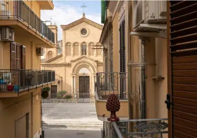 a view of a church from a balcony of a building at Appartamenti Franco il Conte in Bagheria