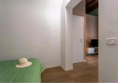 a hat sitting on top of a bed in a room at Appartamenti Franco il Conte in Bagheria
