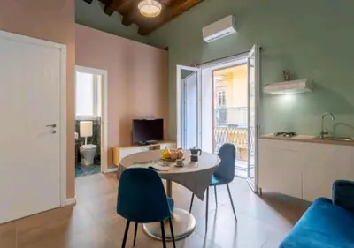 a kitchen and living room with a table and chairs at Appartamenti Franco il Conte in Bagheria