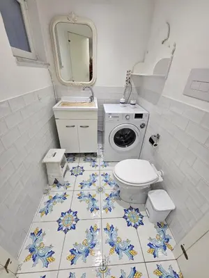 a kitchen with a tile floor and plates on the wall at SUITE AND RELAX TINA a 2 passi dal centro e al foro italico in Palermo
