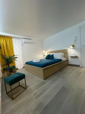 a large bedroom with a bed and a chair at MaRó Loft al Capo in Palermo