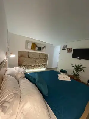 a living room with a couch and a blue carpet at MaRó Loft al Capo in Palermo