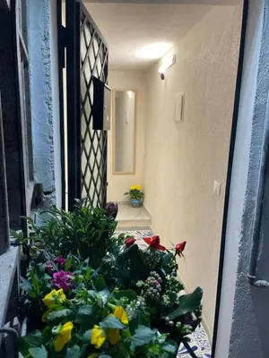 a room with a bunch of flowers in a doorway at MaRó Loft al Capo in Palermo