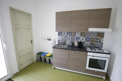 a small kitchen with a sink and a stove at N'Amùri Casa Vacanze in pieno centro storico in Bagheria