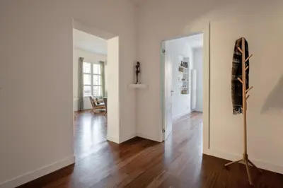 an empty living room with a wooden floor and a mirror at Casa Madà vicino al Politeama by Wonderful Italy in Palermo