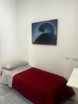 a bedroom with a bed with a red blanket at Maqueda Vibes in Palermo