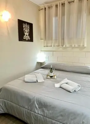 a bedroom with a large bed with towels on it at Merlino Smarthouse alla Zisa in Palermo