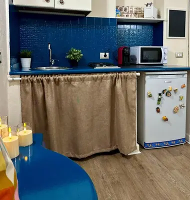 a kitchen with a counter with a sink and a dishwasher at Merlino Smarthouse alla Zisa in Palermo