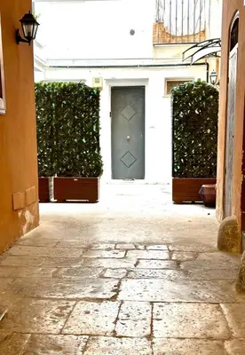 a door in a building with green plants at Merlino Smarthouse alla Zisa in Palermo