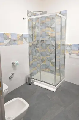a bathroom with a shower and a toilet and a sink at Da 'Nfacci Affittacamere in Carini