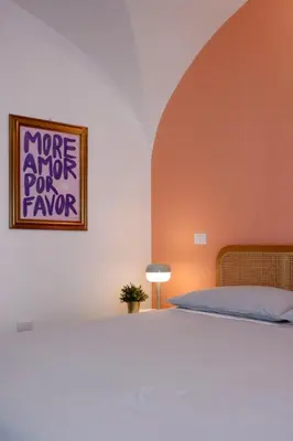 a bedroom with a bed and a painting on the wall at Due Sicilie Ballarò in Palermo