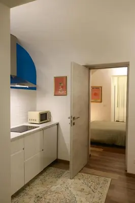 a kitchen with a door leading to a bedroom at Due Sicilie Ballarò in Palermo