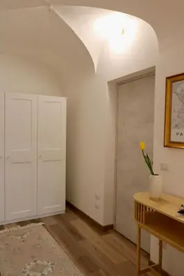 a room with a door and a vase of flowers on a table at Due Sicilie Ballarò in Palermo