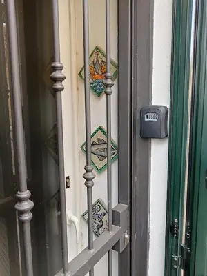 a door with a gate with mosaics on it at IGIEA APARTMENT in Palermo