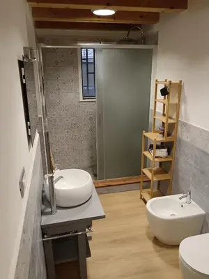 a bathroom with two sinks and a mirror at IGIEA APARTMENT in Palermo