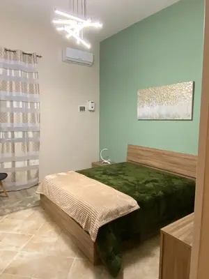 a bedroom with a bed and a green wall at CASA MAGIEM in Palermo