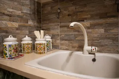 a sink with a faucet on a counter at CASA MAGIEM in Palermo